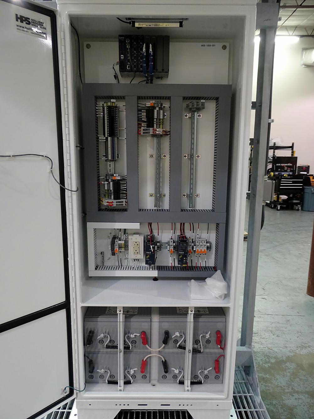 Equipment shelter interior with telecom and control panels