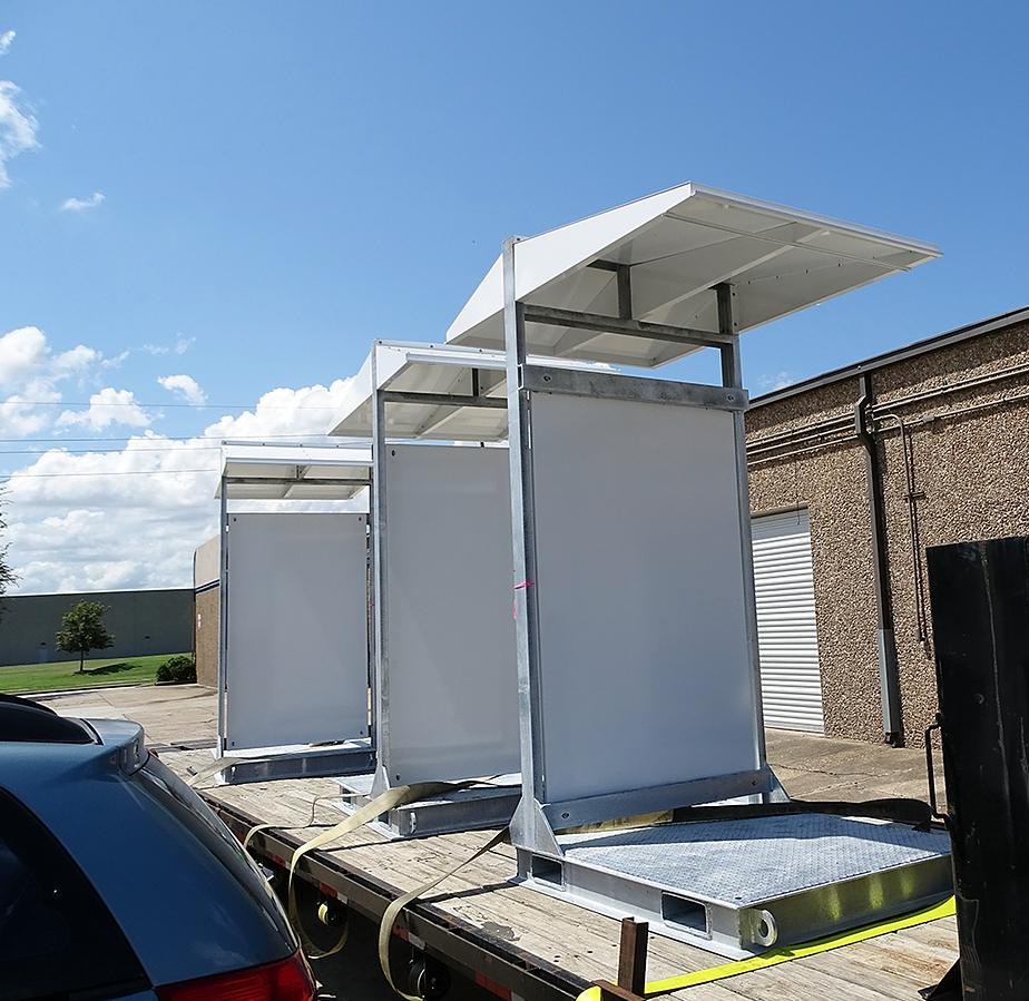 Skid-mounted enclosure shelters staged for delivery